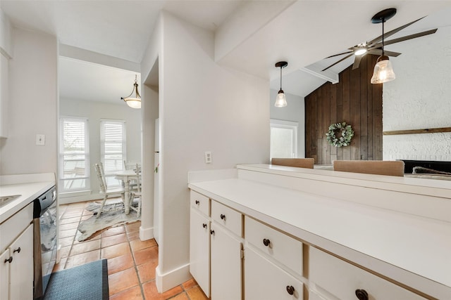 kitchen featuring light countertops, dishwasher, a ceiling fan, white cabinetry, and hanging light fixtures