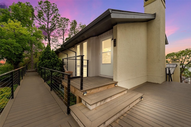deck at dusk featuring french doors