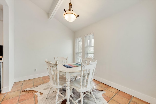 dining room with vaulted ceiling with beams, baseboards, and light tile patterned floors