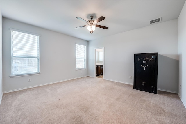unfurnished bedroom featuring visible vents, baseboards, and light carpet