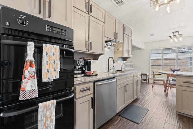 kitchen with a sink, visible vents, dishwasher, light stone countertops, and dobule oven black