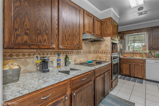 1806 Ray Ave, Bossier City, LA 71112 - kitchen with visible vents, under cabinet range hood, appliances with stainless steel finishes, light countertops, and a sink