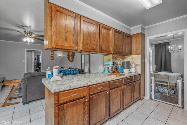 1806 Ray Ave, Bossier City, LA 71112 - kitchen with ornamental molding, light countertops, brown cabinets, ceiling fan with notable chandelier, and light tile patterned flooring