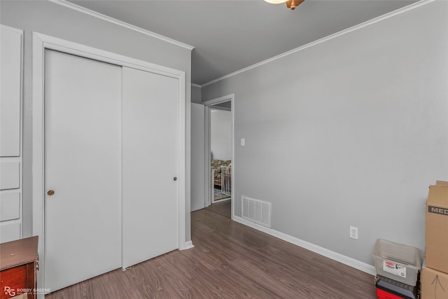 1806 Ray Ave, Bossier City, LA 71112 - unfurnished bedroom with a closet, baseboards, ornamental molding, visible vents, and wood finished floors