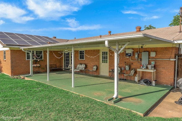 1806 Ray Ave, Bossier City, LA 71112 - back of property featuring brick siding, ceiling fan, a patio, and a yard
