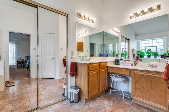 full bath featuring a sink, a wealth of natural light, and double vanity