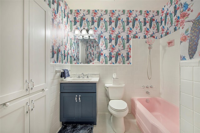full bathroom with tile walls, wallpapered walls, toilet, and wainscoting