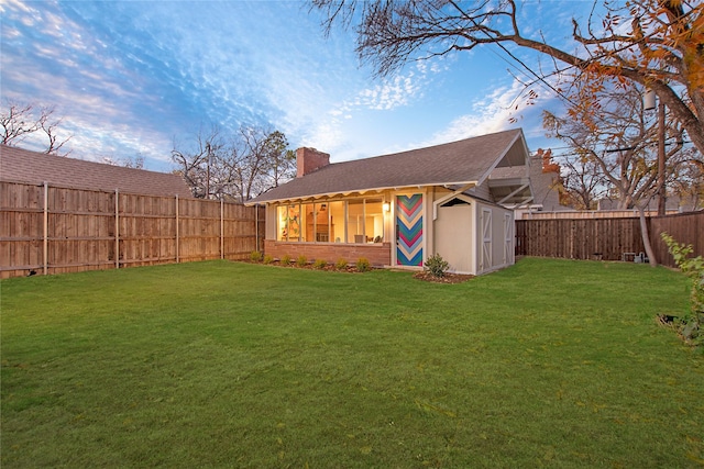exterior space with an outbuilding, a fenced backyard, and a shed