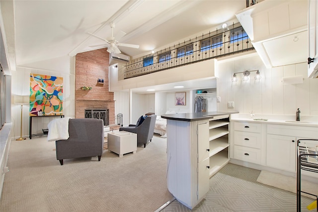 living area featuring a wall mounted AC, light colored carpet, high vaulted ceiling, ceiling fan, and a fireplace