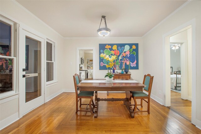dining room with baseboards, crown molding, and parquet flooring