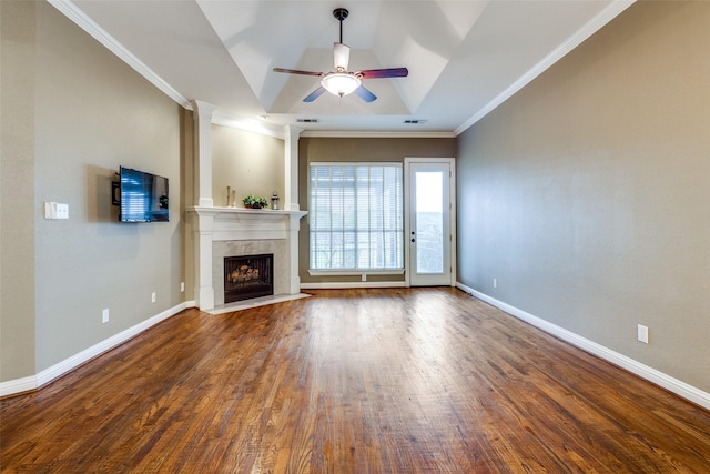 2212 Stone Creek Dr, Mckinney, TX 75072 - unfurnished living room with ceiling fan, a tile fireplace, wood finished floors, crown molding, and baseboards