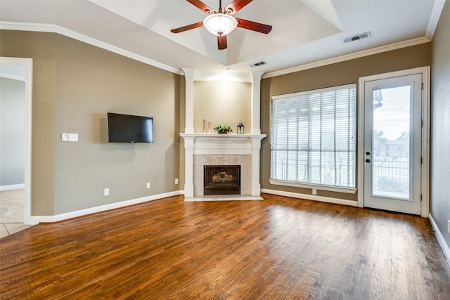 2212 Stone Creek Dr, Mckinney, TX 75072 - unfurnished living room featuring ceiling fan, wood finished floors, a fireplace, baseboards, and crown molding