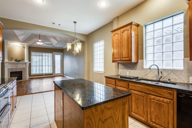 2212 Stone Creek Dr, Mckinney, TX 75072 - kitchen featuring a sink, black dishwasher, brown cabinetry, a ceiling fan, and a center island
