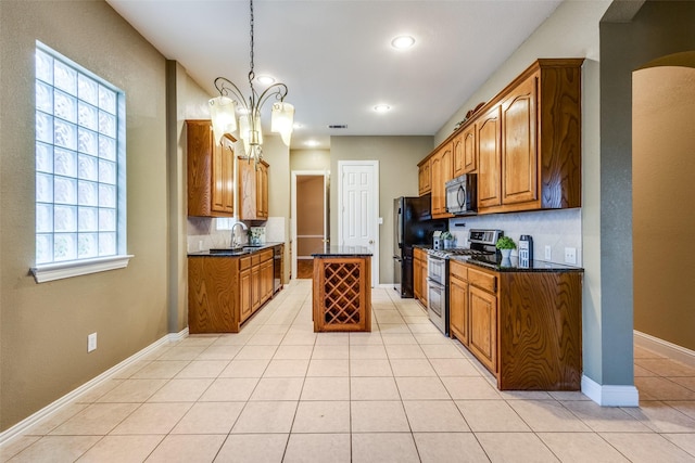 2212 Stone Creek Dr, Mckinney, TX 75072 - kitchen with black appliances, brown cabinetry, a chandelier, a sink, and light tile patterned flooring