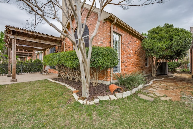 2212 Stone Creek Dr, Mckinney, TX 75072 - view of side of home featuring brick siding, a patio area, a yard, and central AC