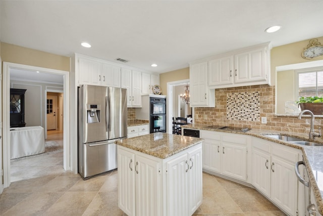 2002 Thames Dr, Arlington, TX 76017 - kitchen featuring appliances with stainless steel finishes, light stone countertops, tasteful backsplash, white cabinets, and recessed lighting