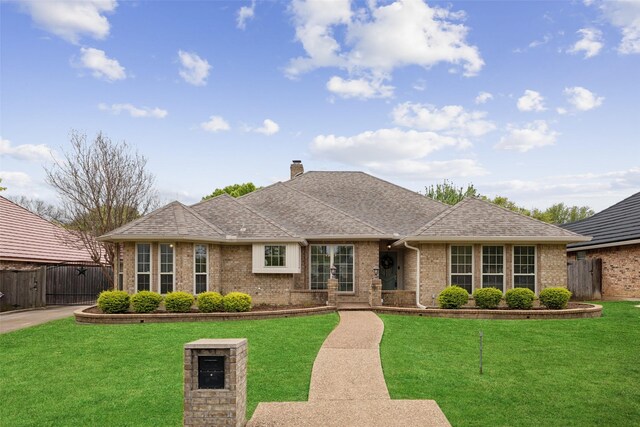 2002 Thames Dr, Arlington, TX 76017 - view of front of house with brick siding, a chimney, roof with shingles, and a gate