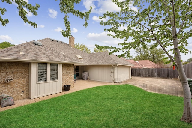 2002 Thames Dr, Arlington, TX 76017 - back of property with driveway, an attached garage, a chimney, and a patio