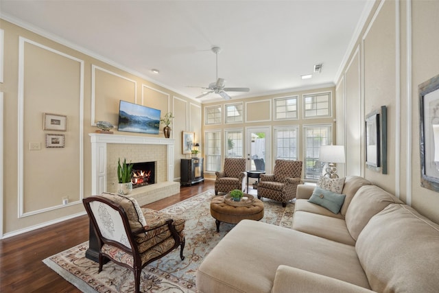 2002 Thames Dr, Arlington, TX 76017 - living room with a decorative wall, crown molding, a brick fireplace, dark wood-type flooring, and ceiling fan