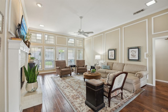 2002 Thames Dr, Arlington, TX 76017 - living room with a decorative wall, a brick fireplace, ceiling fan, dark wood-style floors, and crown molding