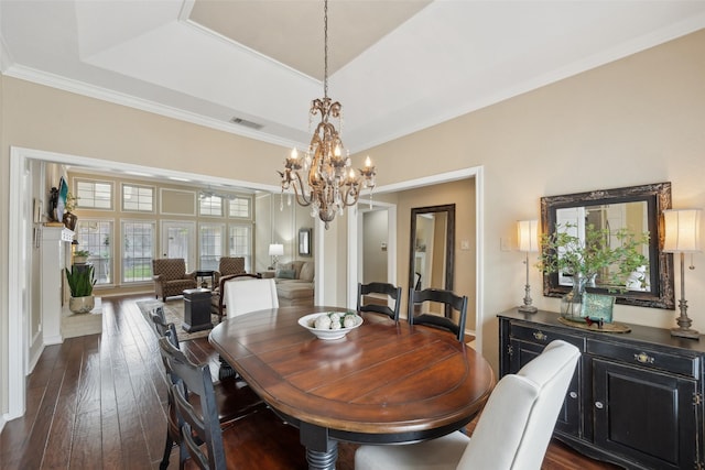 2002 Thames Dr, Arlington, TX 76017 - dining room featuring a chandelier, dark wood-type flooring, crown molding, and a tray ceiling