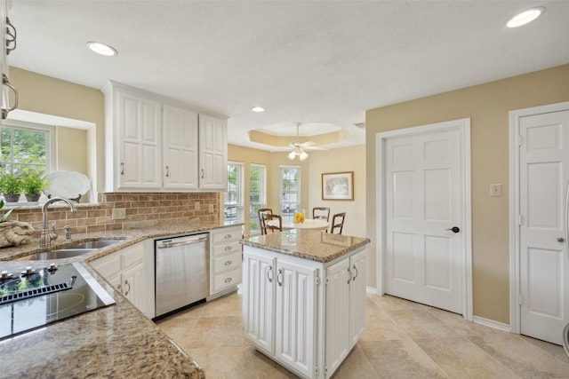 2002 Thames Dr, Arlington, TX 76017 - kitchen featuring dishwasher, white cabinets, decorative backsplash, healthy amount of natural light, and recessed lighting