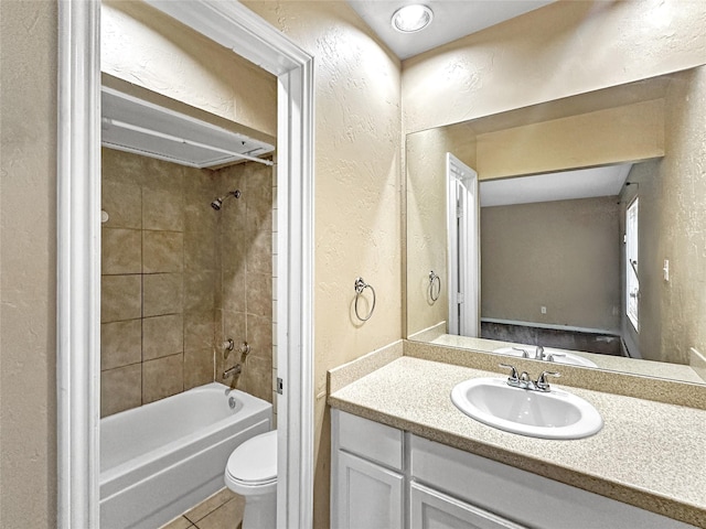 411 Mckinley St, Cedar Hill, TX 75104 - full bathroom with a textured wall, toilet, vanity, tile patterned flooring, and shower / bathtub combination