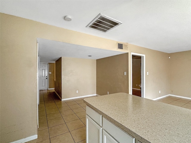 411 Mckinley St, Cedar Hill, TX 75104 - kitchen with light tile patterned flooring, white cabinetry, baseboards, open floor plan, and light countertops