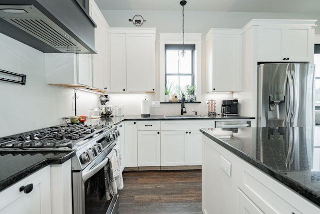 kitchen featuring dark wood-style flooring, range hood, a sink, white cabinets, and appliances with stainless steel finishes