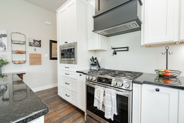 kitchen featuring white cabinetry, appliances with stainless steel finishes, and dark wood-type flooring