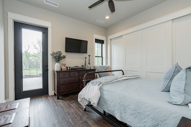 bedroom featuring a closet, dark wood-type flooring, access to exterior, and visible vents