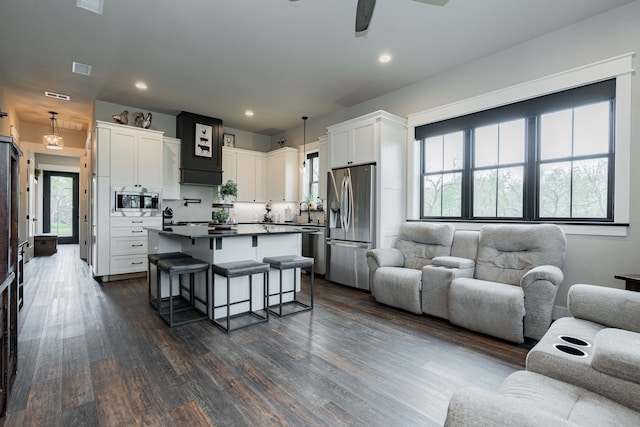living room with visible vents, a ceiling fan, recessed lighting, and dark wood-style flooring