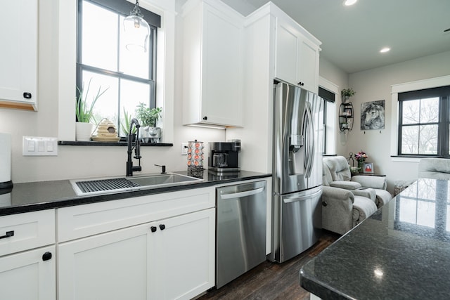 kitchen with recessed lighting, dark wood-type flooring, a sink, white cabinets, and appliances with stainless steel finishes