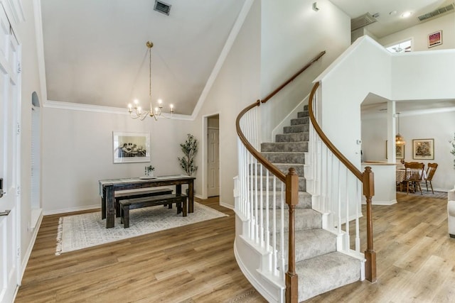 8716 Falls Rd, Irving, TX 75063 - foyer featuring high vaulted ceiling, light wood-style floors, a chandelier, stairs, and baseboards
