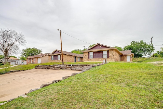 view of front of property with a front yard and brick siding