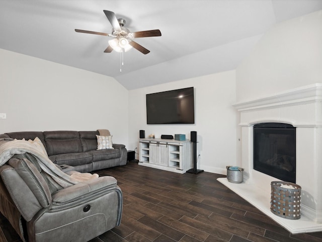 living room with vaulted ceiling, dark wood-style flooring, baseboards, and ceiling fan