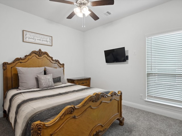 carpeted bedroom with baseboards, visible vents, and ceiling fan
