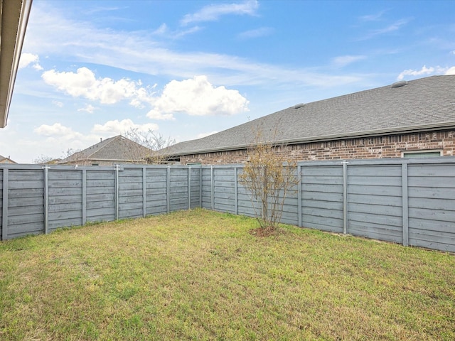 view of yard with a fenced backyard