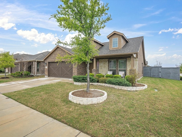 view of front of home featuring a shingled roof, concrete driveway, brick siding, a front yard, and a garage
