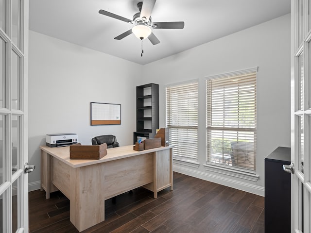 office featuring dark wood finished floors, baseboards, and a ceiling fan