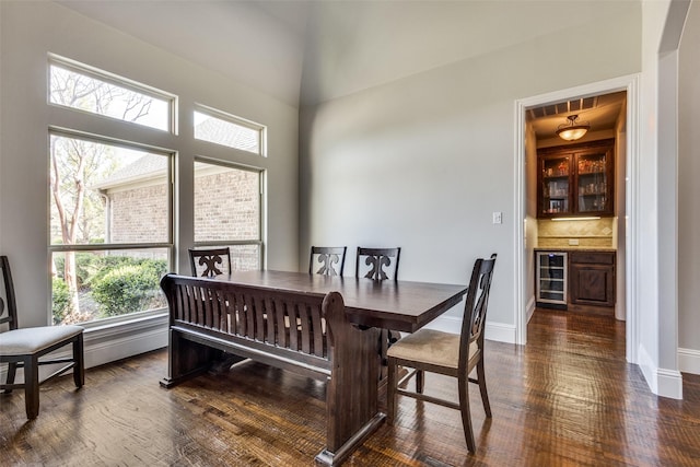 1891 Fostermill Dr, Prosper, TX 75078 - dining area with beverage cooler, dark wood-style flooring, and baseboards