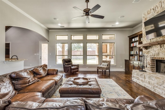1891 Fostermill Dr, Prosper, TX 75078 - living room featuring a fireplace, a ceiling fan, crown molding, dark wood-style flooring, and recessed lighting