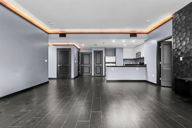 1200 Main St Unit 1511, Dallas, TX 75202 - unfurnished living room featuring baseboards, visible vents, and dark wood-type flooring