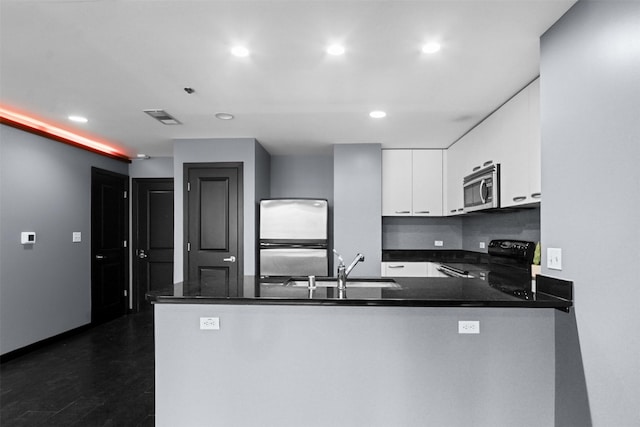 1200 Main St Unit 1511, Dallas, TX 75202 - kitchen featuring stainless steel microwave, refrigerator, visible vents, black electric range, and white cabinets