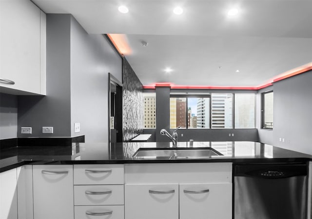 1200 Main St Unit 1511, Dallas, TX 75202 - kitchen with a sink, dark countertops, white cabinetry, stainless steel dishwasher, and recessed lighting
