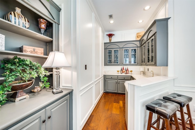 4816 Cape Coral Dr, Dallas, TX 75287 - bar with recessed lighting, wet bar, dark wood-style floors, visible vents, and a decorative wall