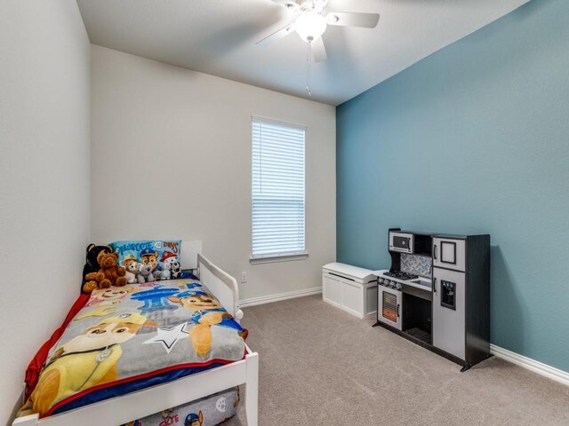 carpeted bedroom featuring baseboards and a ceiling fan