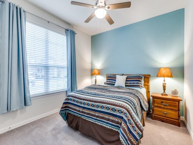 bedroom featuring baseboards, carpet, and multiple windows