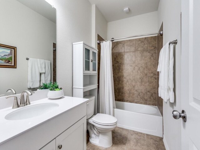 bathroom with toilet, tile patterned flooring, shower / tub combo, and vanity
