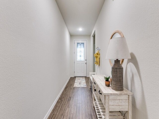entryway with recessed lighting, baseboards, and dark wood-style floors